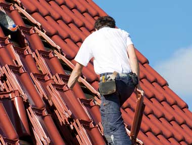 John is working on a roof upgrade using clay tiles